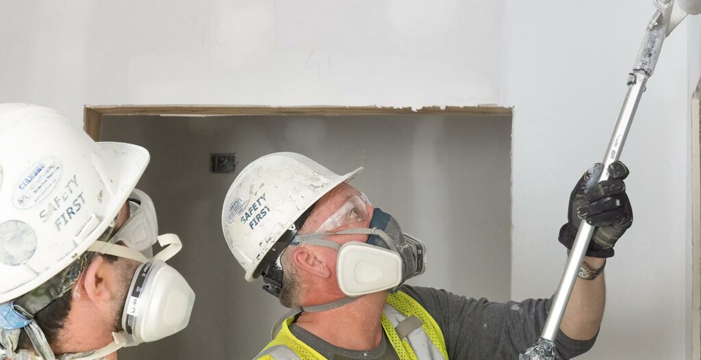 workers painting with masks