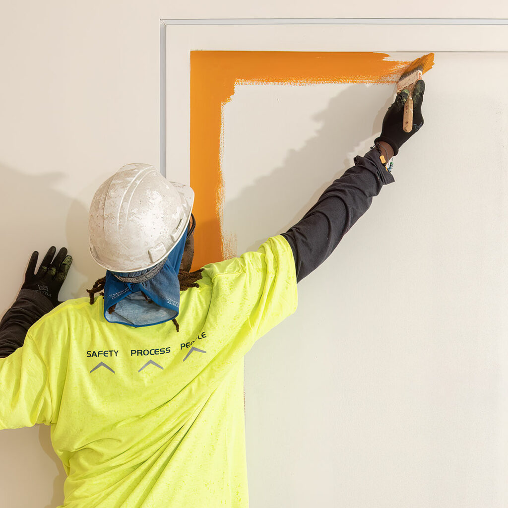 worker painting a door